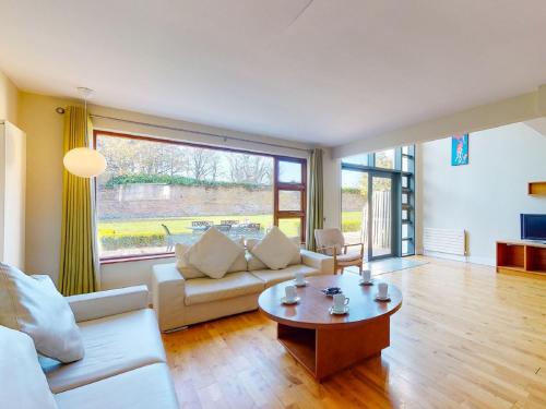 a living room with a couch and a table at Holiday Home Castlemartyr Holiday Lodge by Interhome in Cork