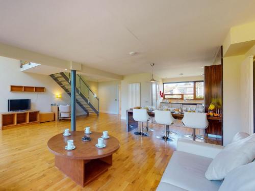 a living room with a table and white chairs at Holiday Home Castlemartyr Holiday Lodge by Interhome in Cork