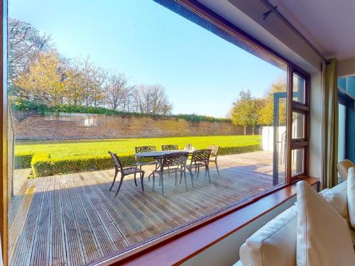 a view of a table and chairs from a window at Holiday Home Castlemartyr Holiday Lodge by Interhome in Cork
