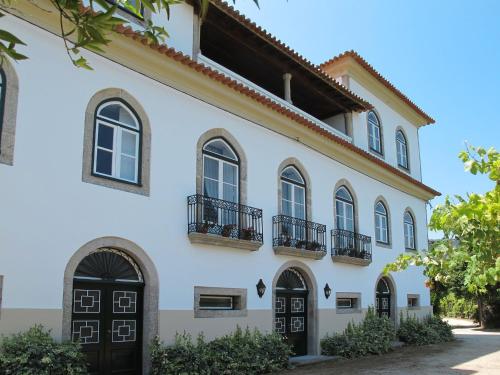 a white house with black doors and windows at Holiday Home De Ferreira by Interhome in Ponte de Lima