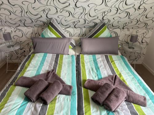 a bedroom with a bed with two pillows on it at Apartment Dori by Interhome in Westerholt