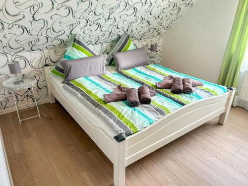 a bed with two brown teddy bears on it at Apartment Dori by Interhome in Westerholt