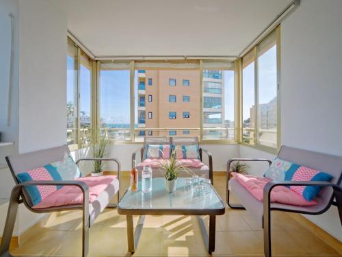 a balcony with a table and chairs and windows at Apartment Mare Nostrum-1 by Interhome in Calpe