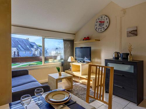 a living room with a couch and a tv at Studio Maison Port En Dro-5 by Interhome in Carnac