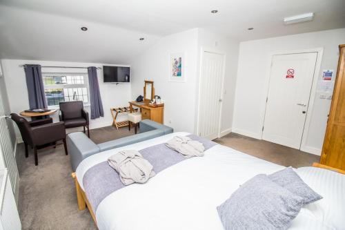 a bedroom with a bed with two towels on it at The Saxon Inn in Bishop Auckland