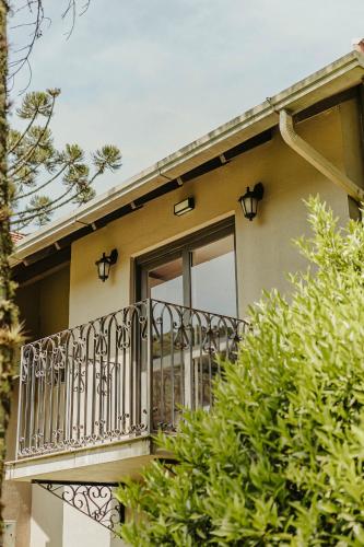 a balcony of a house with a window at Pousada Golden Hills in Canela