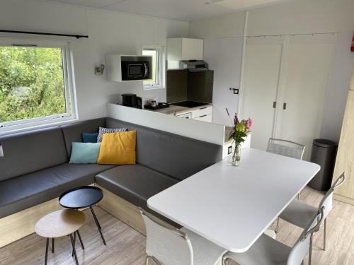 a living room with a couch and a table at Holiday Home Natuurlijk de Veenhoop by Interhome in De Veenhoop