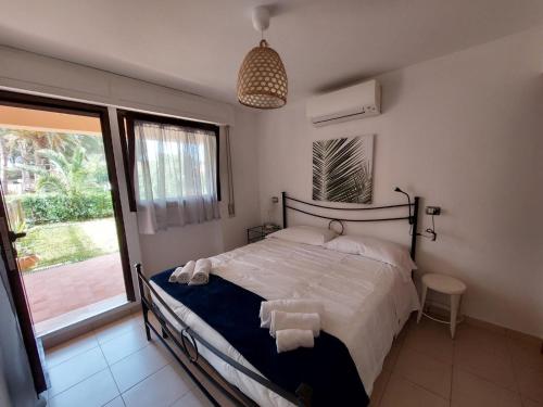 a bedroom with a bed with towels on it at Lido I Palmizi in Capoliveri