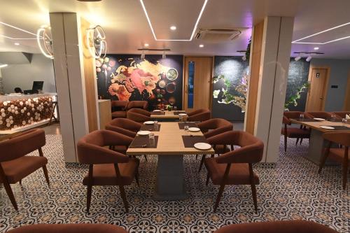 a restaurant with a table and chairs in a room at KP Hotels in Begusarai