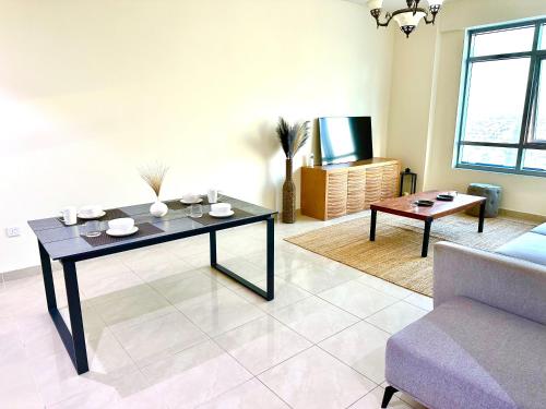 a living room with a table and a couch at Luxury Apartment 2 BR Al Majaz 2 view in Sharjah