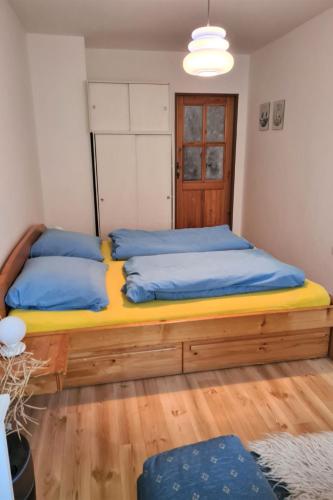 a bedroom with a large bed with blue pillows at Holiday Home Kralovice by Interhome in Nebahovy