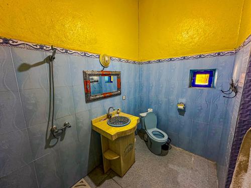 a bathroom with a sink and a toilet at Riad Les Roches Merzouga in Merzouga