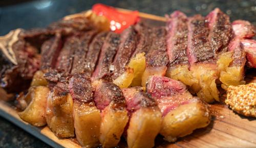 a pile of meat on a wooden cutting board at Hotel Crisol de las Rías in Miño