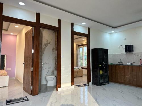 a large bathroom with a toilet and a sink at Serene, charming and party friendly Farmhouse sec 150 Noida in Greater Noida