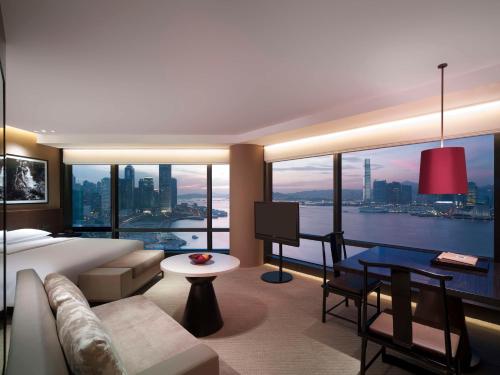 a hotel room with a bed and a large window at Grand Hyatt Hong Kong in Hong Kong