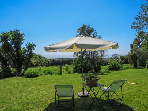 a table and two chairs under an umbrella at Holiday Home Casa da Quinta de Pedral by Interhome in Castelo do Neiva