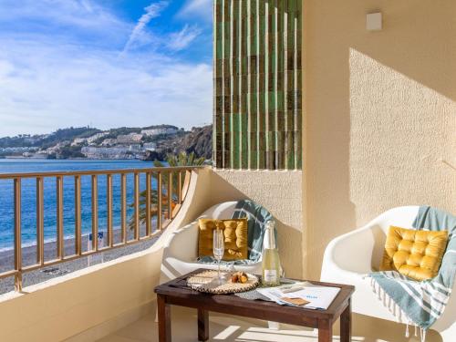 a balcony with a table and a view of the ocean at Apartment Balcón de Cotobro I by Interhome in Almuñécar