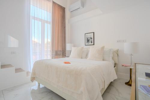 那不勒斯La Corte dei Mille Luxury的一间带大床和窗户的白色卧室