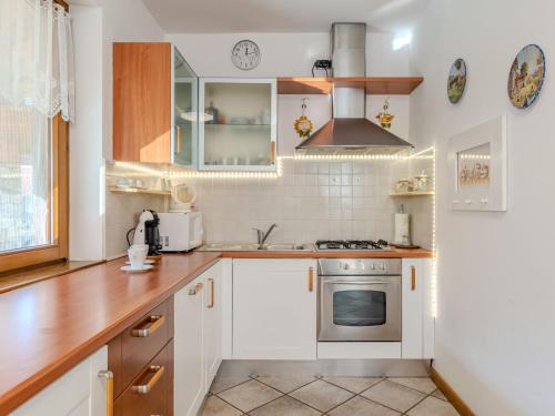a kitchen with white cabinets and a stove at Holiday Home Mina by Interhome in Carriola