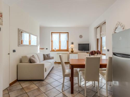 a kitchen and living room with a table and a couch at Holiday Home Mina by Interhome in Carriola
