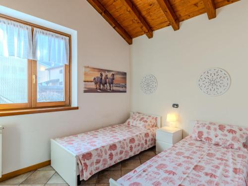 a bedroom with two beds and a window at Holiday Home Mina by Interhome in Carriola