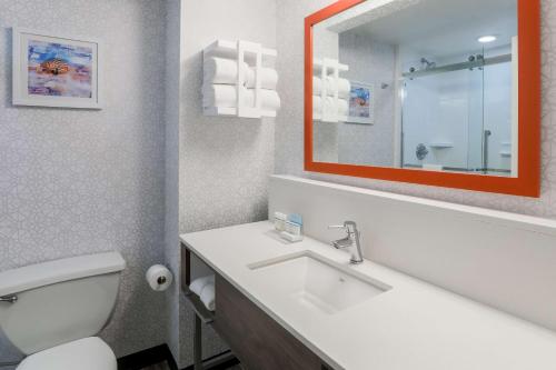 a bathroom with a toilet and a sink and a mirror at Hampton Inn Fort Walton Beach in Fort Walton Beach