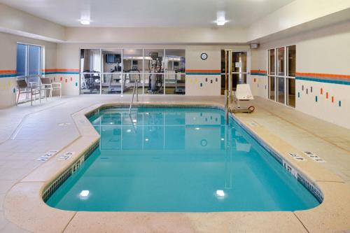 a swimming pool with blue water in a building at Fairfield Inn & Suites by Marriott Amarillo Airport in Amarillo