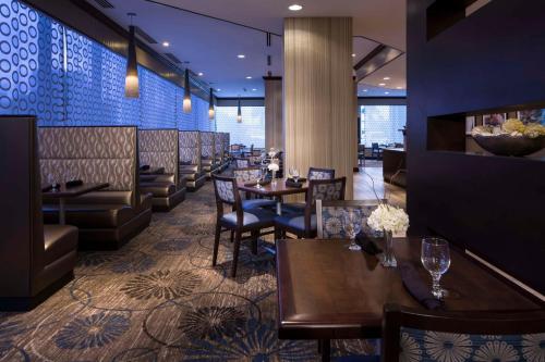 a restaurant with tables and chairs and a bar at DoubleTree by Hilton Jacksonville Riverfront, FL in Jacksonville