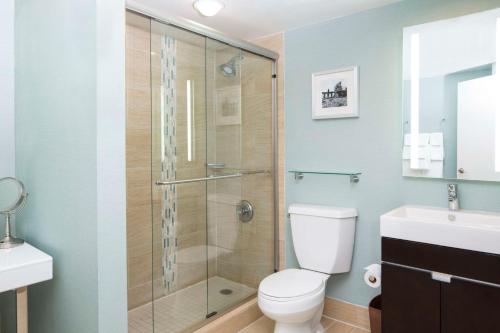a bathroom with a shower and a toilet and a sink at DoubleTree by Hilton Jacksonville Riverfront, FL in Jacksonville