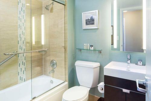 a bathroom with a toilet and a shower and a sink at DoubleTree by Hilton Jacksonville Riverfront, FL in Jacksonville