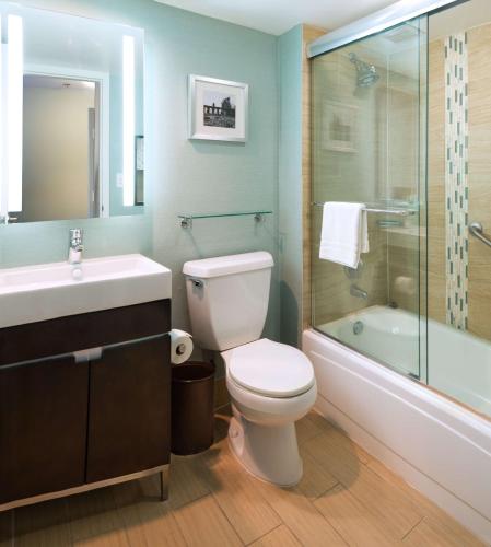 a bathroom with a toilet and a sink and a tub at DoubleTree by Hilton Jacksonville Riverfront, FL in Jacksonville