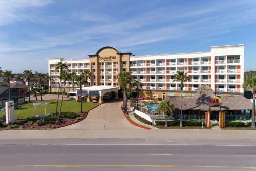 a large hotel on the side of a street at DoubleTree by Hilton Galveston Beach in Galveston