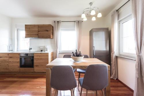 a kitchen with a table and chairs in a room at Terasse Jeruzalem Apartments in Hermanci