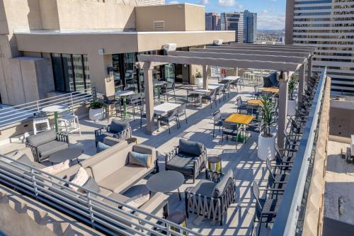 a rooftop patio with chairs and tables on a building at Hilton Garden Inn Phoenix Downtown in Phoenix