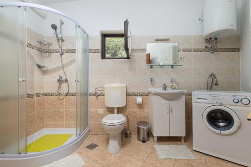 a bathroom with a shower and a toilet and a sink at St. Bečić in Poreč