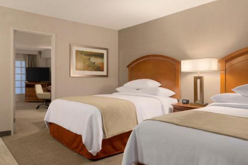 a hotel room with two beds and a desk at Embassy Suites by Hilton El Paso in El Paso