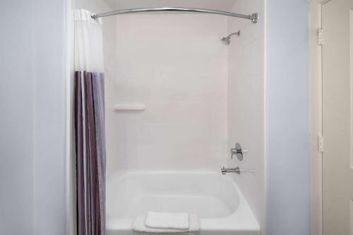 a white bathroom with a tub and a shower at La Quinta by Wyndham Austin - Cedar Park in Cedar Park