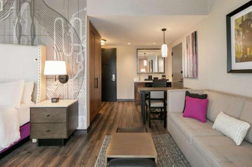 a living room with a couch and a table at Embassy Suites By Hilton Berkeley Heights in Berkeley Heights