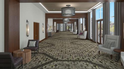 a corridor of a hotel with chairs and tables at Embassy Suites By Hilton Berkeley Heights in Berkeley Heights