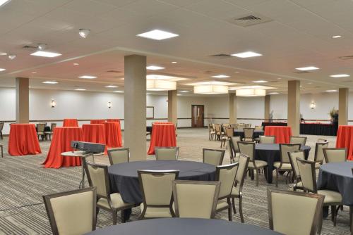 a banquet hall with tables and chairs in a room at The Lismore Hotel Eau Claire - a DoubleTree by Hilton in Eau Claire