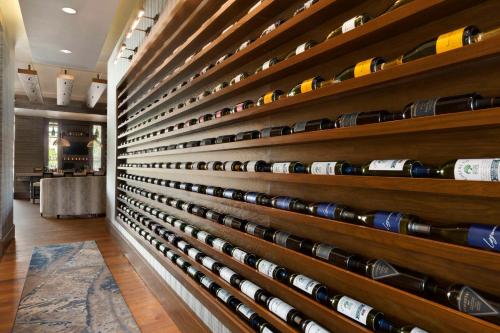 a wall of wine bottles in a wine cellar at Embassy Suites by Hilton Greenville Downtown Riverplace in Greenville