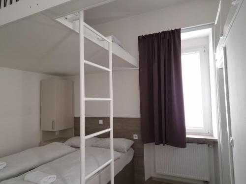 a room with two bunk beds and a window at Rooms Ambrožič in Ljubljana