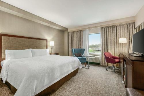 a hotel room with a bed and a television at Hampton Inn Penn Yan, NY in Penn Yan