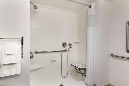 a white bathroom with a shower and a toilet at Hampton Inn Penn Yan, NY in Penn Yan