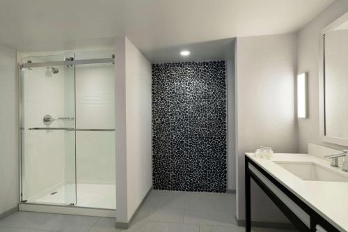 a bathroom with a shower with a glass door at Hilton Garden Inn Springfield in Springfield