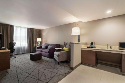 a hotel room with a couch and a living room at Hilton Garden Inn Springfield in Springfield