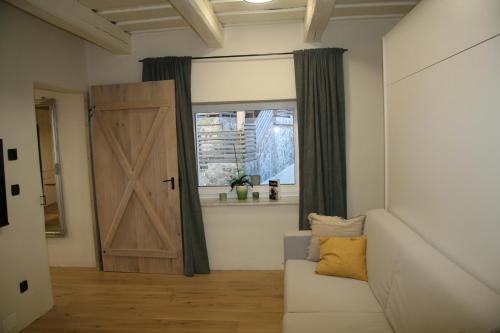 a living room with a door and a couch and a window at Terasse Jeruzalem Apartments in Hermanci