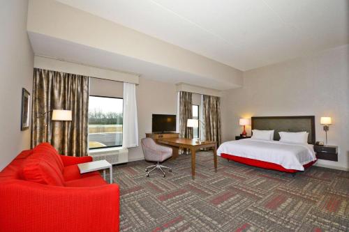 a large hotel room with a bed and a desk at Hampton Inn Pulaski, TN in Pulaski
