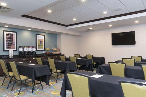 a conference room with tables and chairs and a flat screen tv at Hampton Inn Westfield Indianapolis in Westfield