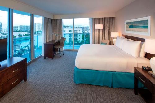 a large hotel room with a bed and a television at DoubleTree Resort Hollywood Beach in Hollywood